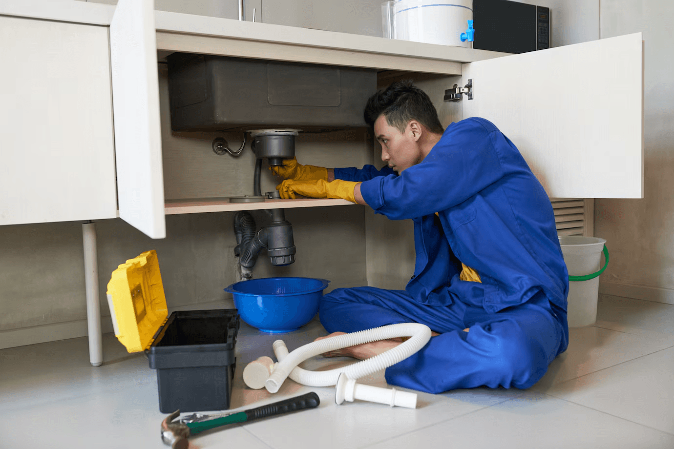 Plumber cleaning a clogged drain